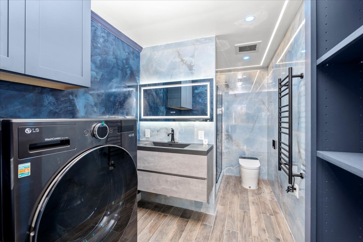 Modern high-end bathroom with Italian textured porcelain floor tile, large format wall tile, and Venetian Plaster